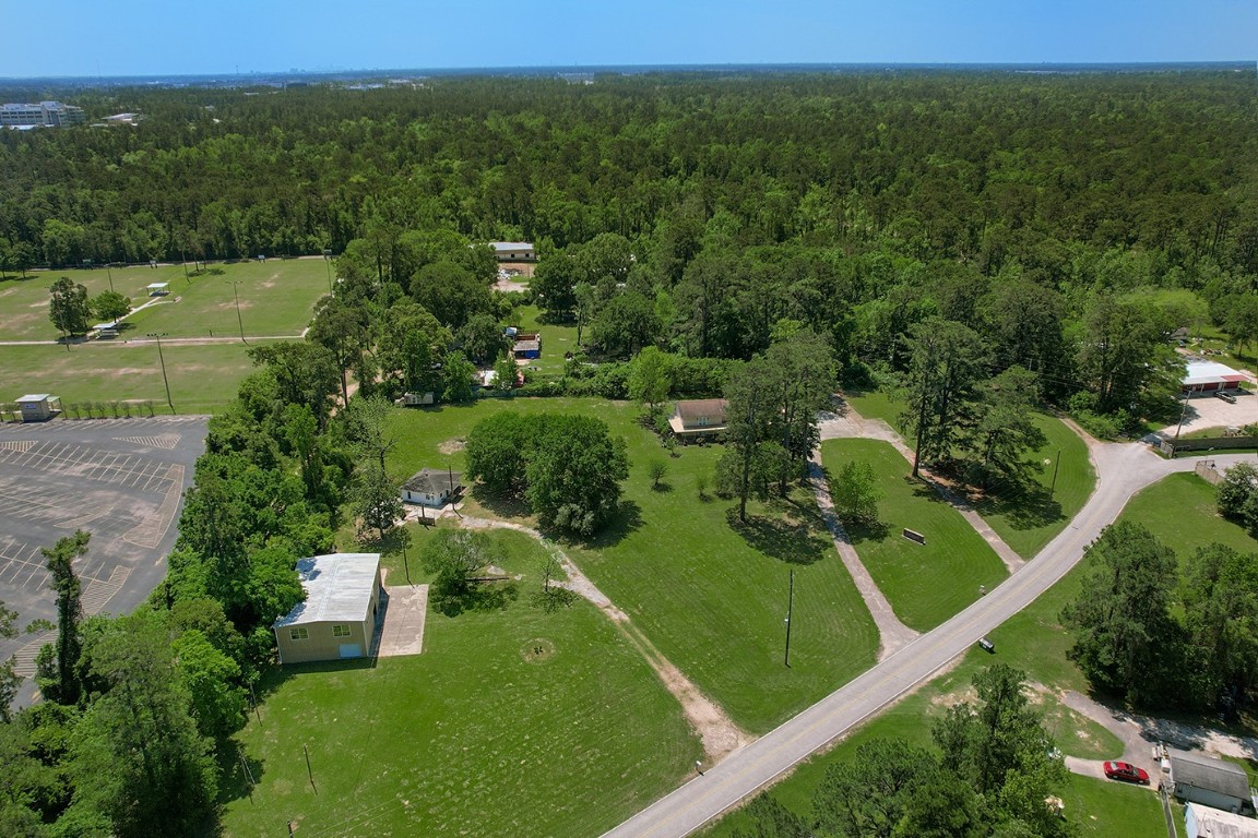 1231 Pruitt Road Spring, TX 77380 - Photo 34 of 37 an aerial view of green landscape with trees houses and mountain view