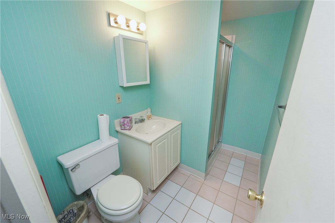 817 Rickel Circle Akron, OH 44333 - Photo 39 of 49 Bathroom featuring a shower, ceramic tile flooring, toilet, and vanity