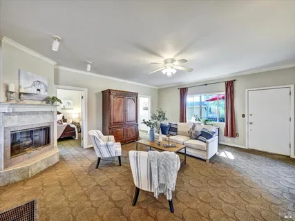 a living room with furniture and a chandelier