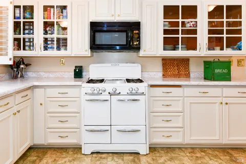 a kitchen with a stove sink and microwave