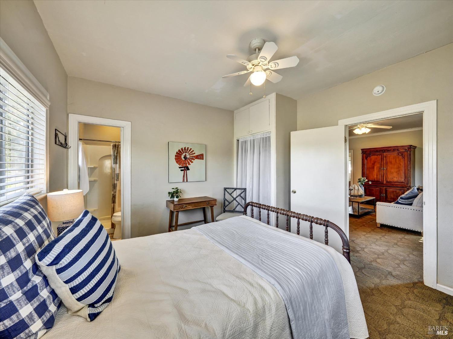 2060 Hagen Road Napa, CA 94558 - Photo 22 of 56 a bedroom with a bed and a chandelier