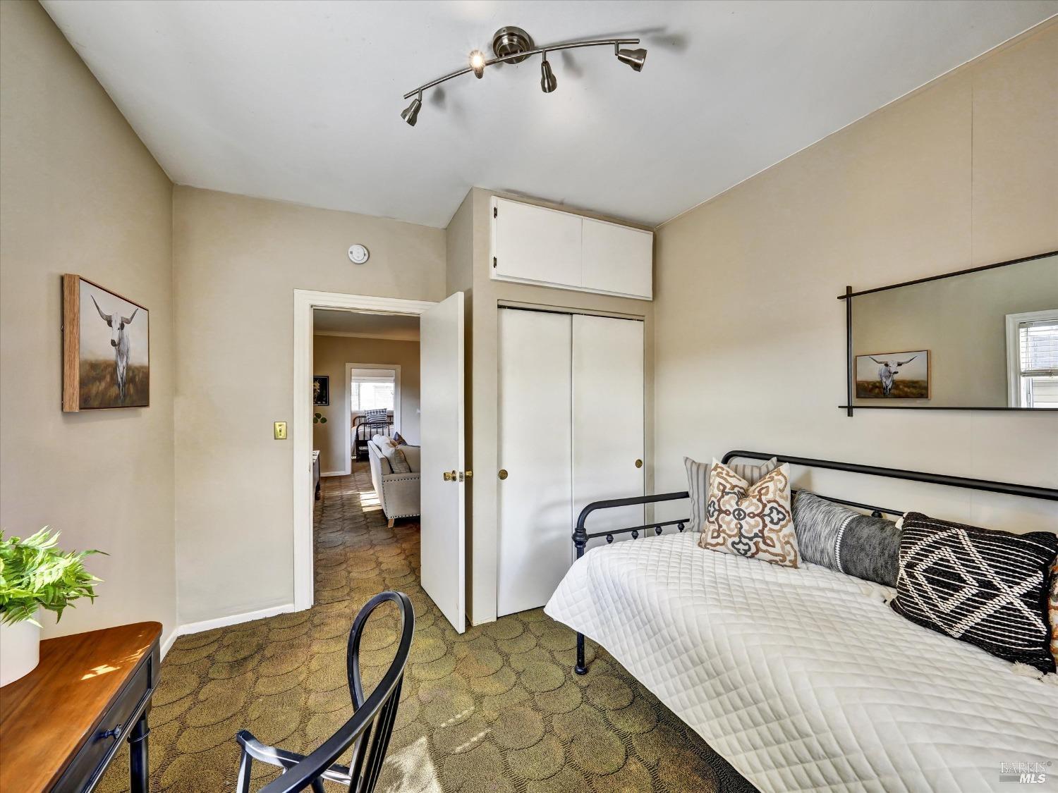 2060 Hagen Road Napa, CA 94558 - Photo 25 of 56 a bedroom with a bed and wooden floor