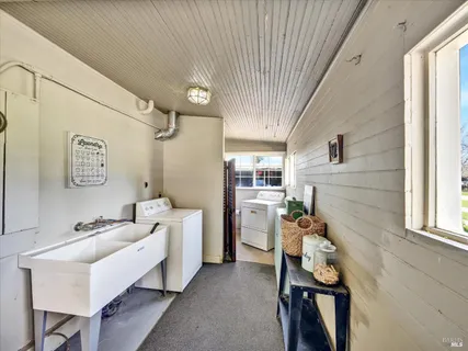 a view of a backyard with a patio and fire pit