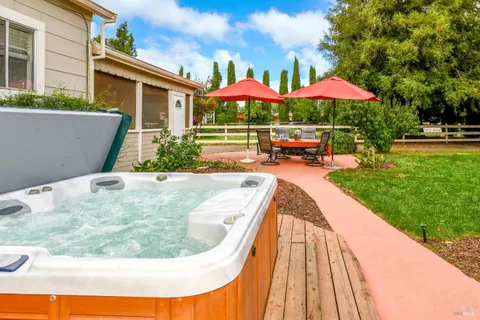 a view of a backyard with sitting area and furniture