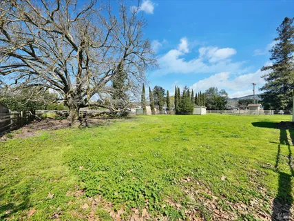 an aerial view of residential houses with outdoor space and street view