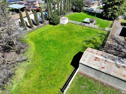an aerial view of a house with a yard and garden
