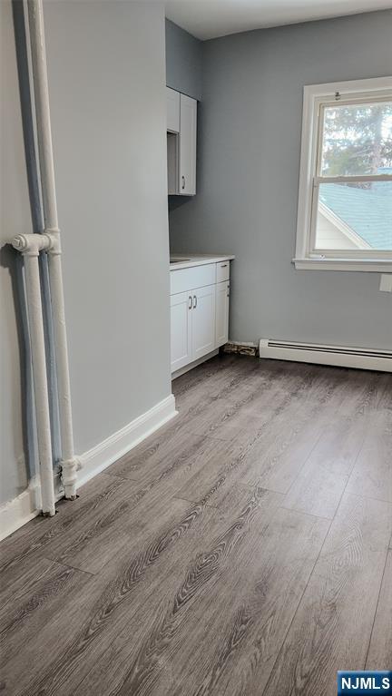 566 Valley Street, Unit 2 Orange, NJ 07050 - Photo 12 of 12 an empty room with wooden floor and windows