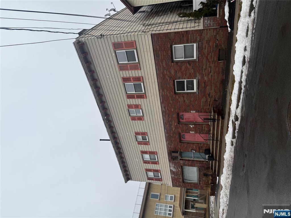 566 Valley Street, Unit 2 Orange, NJ 07050 - Photo 2 of 12 a front view of a house with a yard