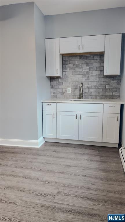 566 Valley Street, Unit 2 Orange, NJ 07050 - Photo 5 of 12 a kitchen with granite countertop a sink cabinets and wooden floor