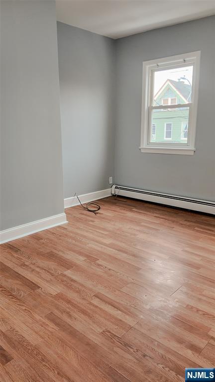 566 Valley Street, Unit 2 Orange, NJ 07050 - Photo 6 of 12 an empty room with wooden floor and windows