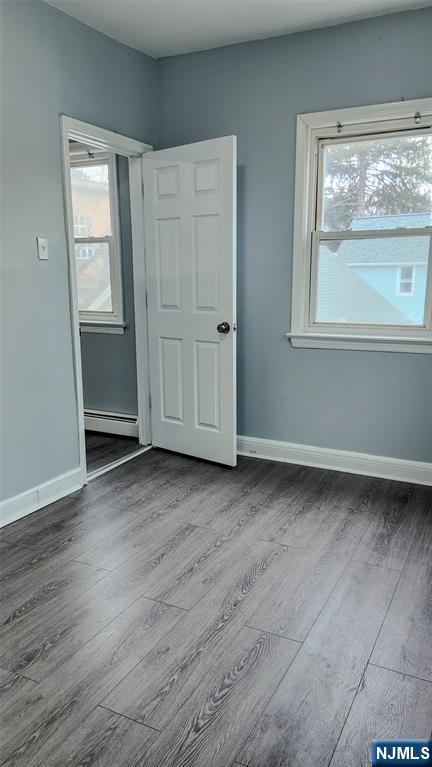 566 Valley Street, Unit 2 Orange, NJ 07050 - Photo 7 of 12 an empty room with wooden floor and windows