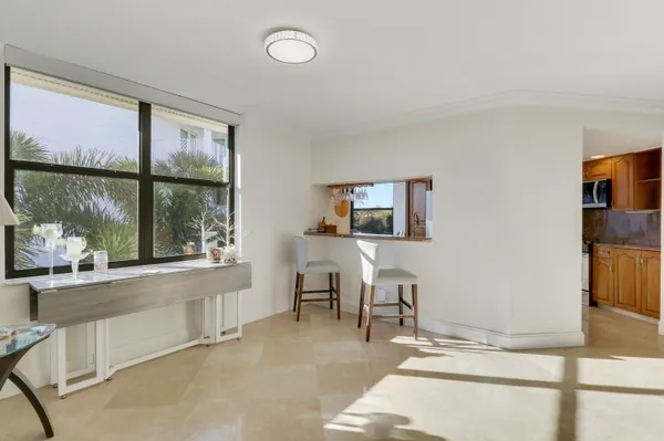 a living room with furniture a window and a flat screen tv