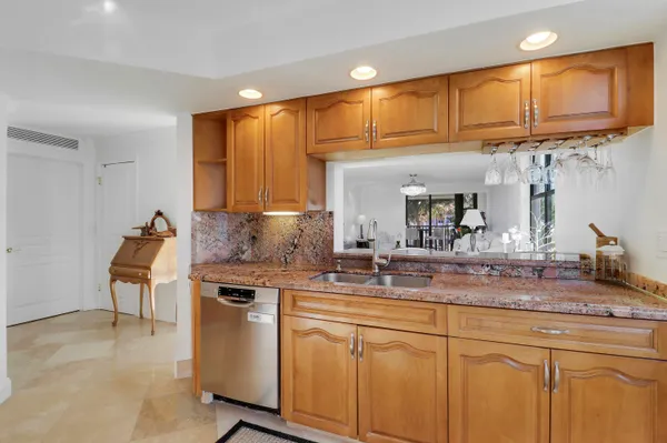 a kitchen with stainless steel appliances granite countertop a sink and cabinets