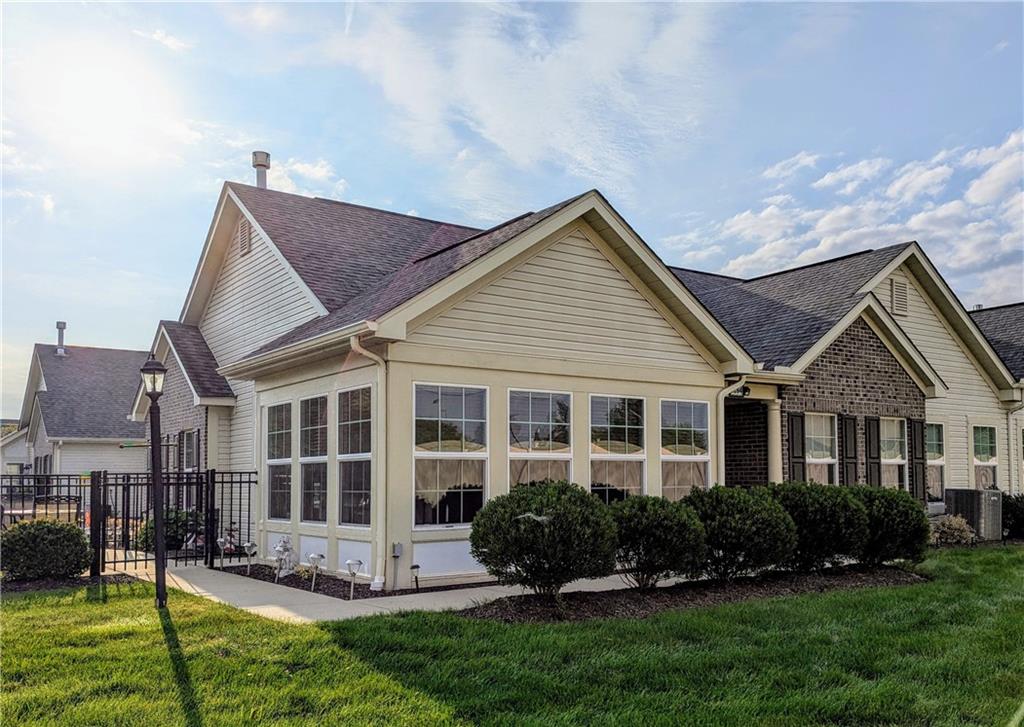 a front view of a house with a yard and outdoor seating
