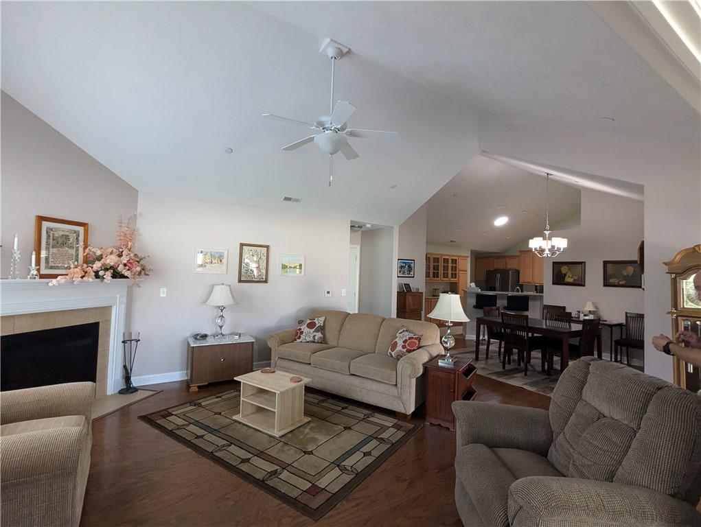 3204 Tudor Drive Butler, PA 16001 - Photo 6 of 35 a living room with furniture a fireplace and a chandelier
