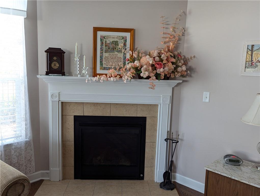 3204 Tudor Drive Butler, PA 16001 - Photo 7 of 35 a living room with a fireplace and flowers