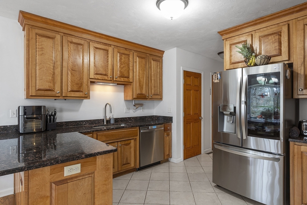 1 Gary Road Templeton, MA 01468 - Photo 14 of 33 a kitchen with granite countertop stainless steel appliances and wooden cabinets