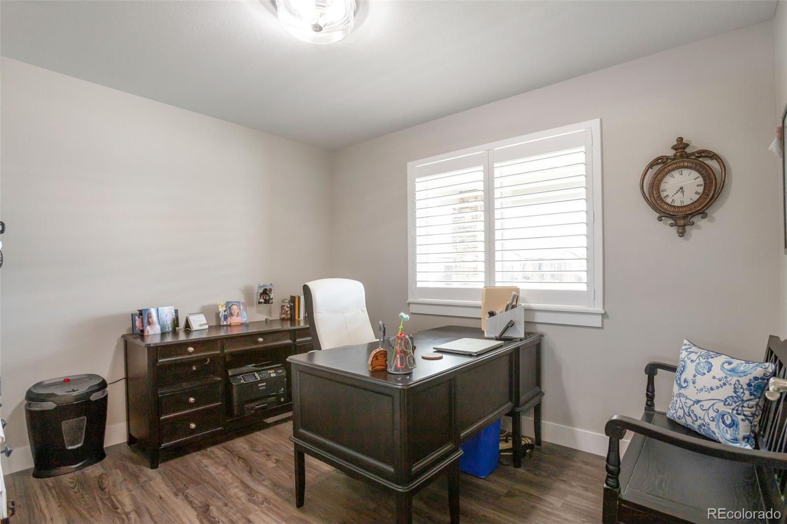 3711 Harrier Hawk Road Dacono, CO 80514 - Photo 14 of 40 a living room with furniture and wooden floor