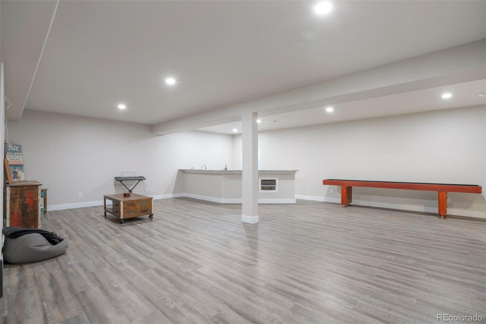 3711 Harrier Hawk Road Dacono, CO 80514 - Photo 25 of 40 a room with wooden floor and furniture