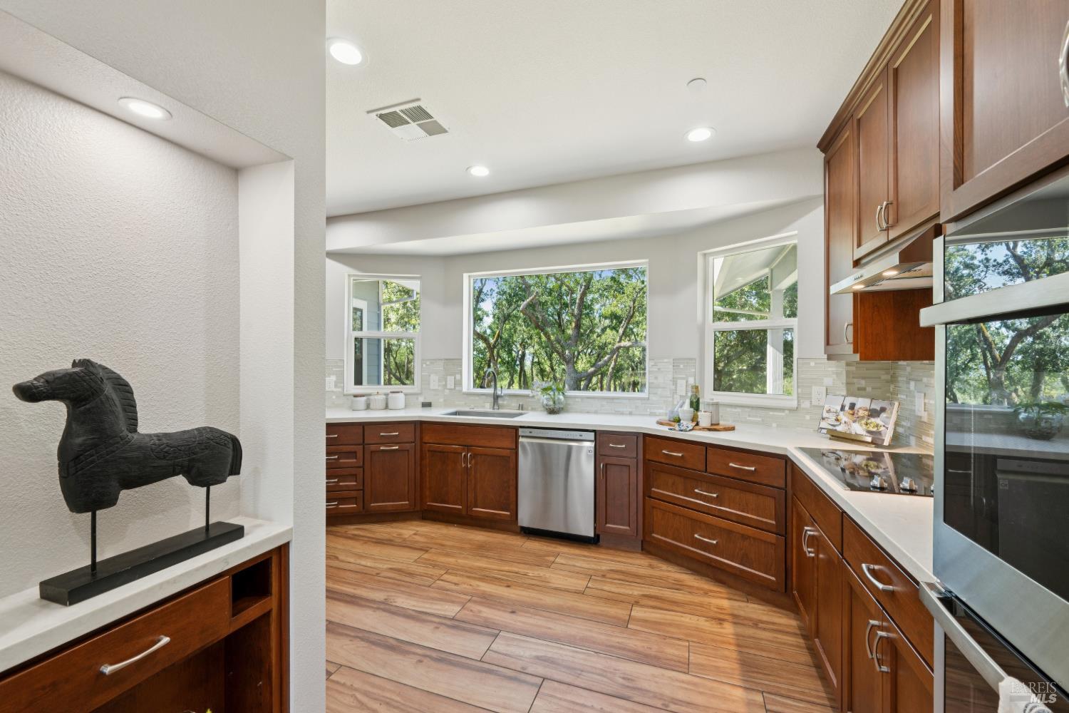4665 Upper Ridge Road Santa Rosa, CA 95404 - Photo 16 of 71 a large kitchen with stainless steel appliances granite countertop a sink and wooden cabinets