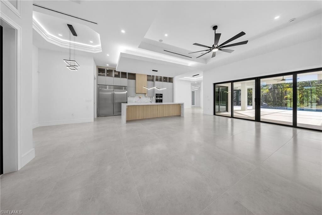 522 17th Street Southwest Naples, FL 34117 - Photo 14 of 50 a view of a kitchen with kitchen island wooden floor and stainless steel appliances