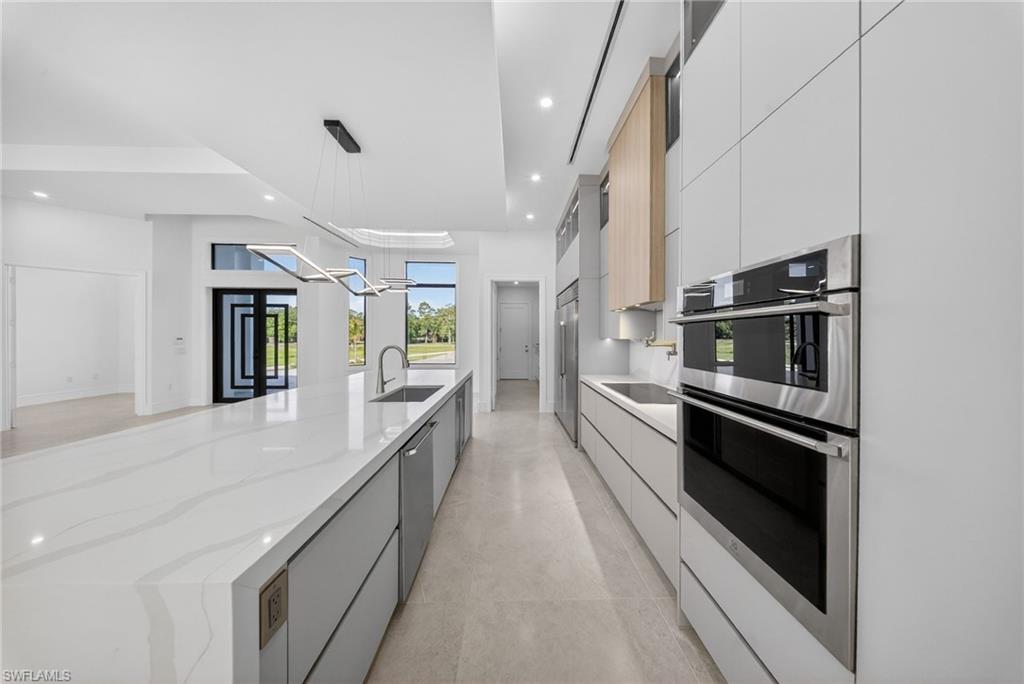 522 17th Street Southwest Naples, FL 34117 - Photo 18 of 50 a large white kitchen with stainless steel appliances