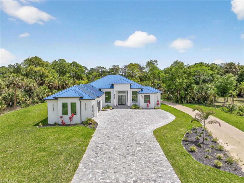 522 17th Street Southwest Naples, FL 34117 - Photo 2 of 50 a front view of a house with garden