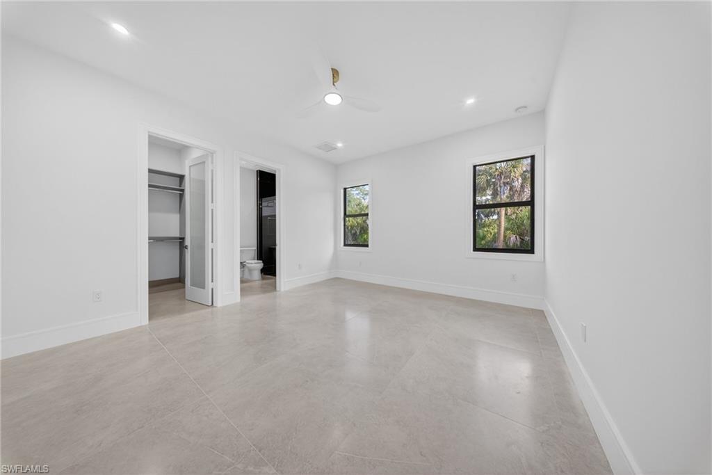 522 17th Street Southwest Naples, FL 34117 - Photo 28 of 50 an empty room with a window and a ceiling fan