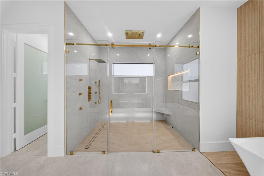 522 17th Street Southwest Naples, FL 34117 - Photo 30 of 50 a bathroom with a glass shower door