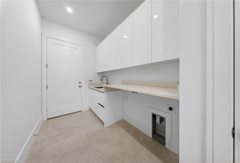 522 17th Street Southwest Naples, FL 34117 - Photo 33 of 50 a utility room with cabinets washer and dryer