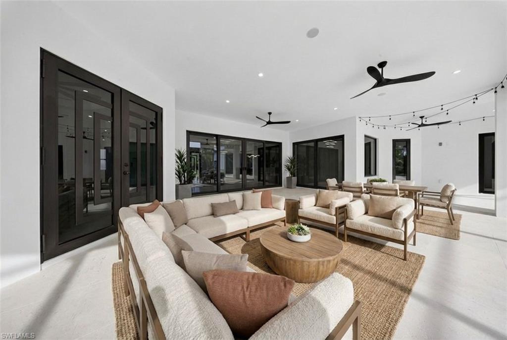 522 17th Street Southwest Naples, FL 34117 - Photo 5 of 50 a living room with furniture and a large window