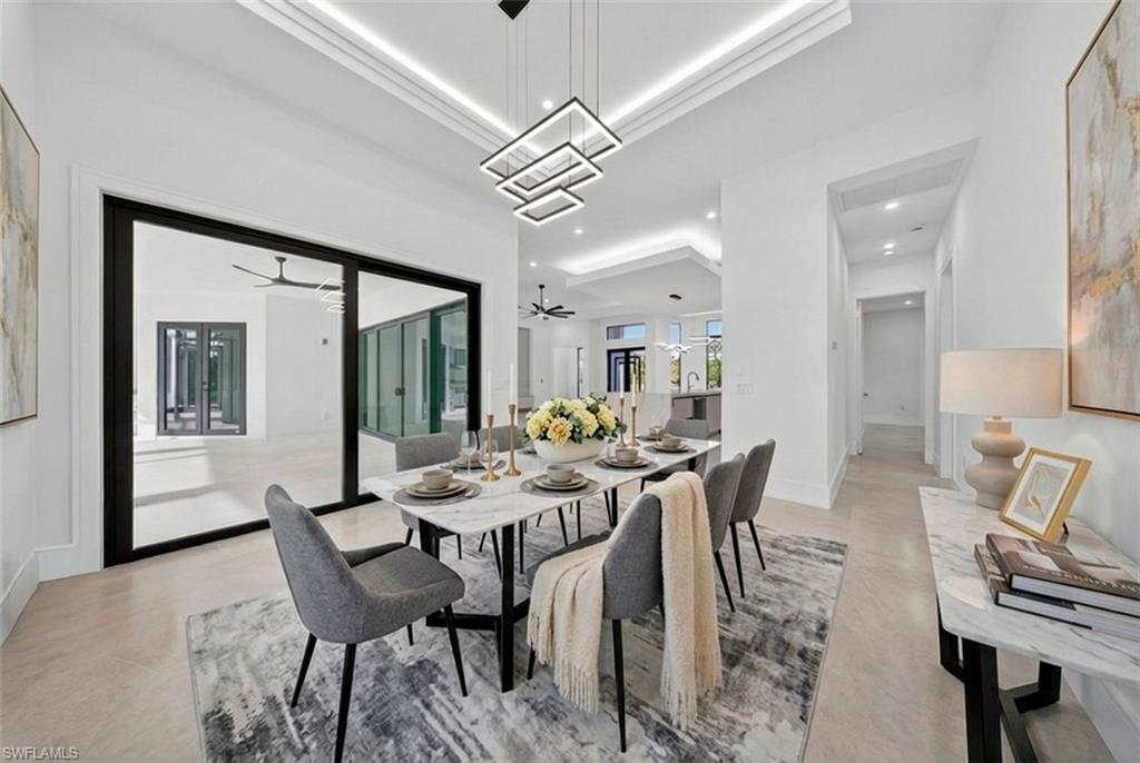522 17th Street Southwest Naples, FL 34117 - Photo 7 of 50 a view of a dining room with furniture and chandelier