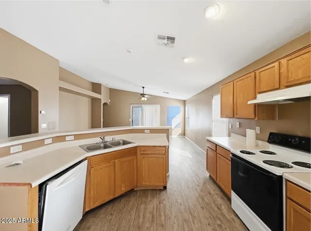 a kitchen with a sink stove and cabinets