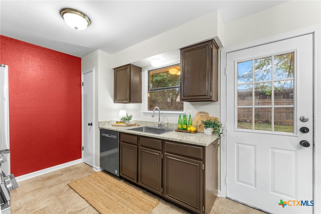 2504 Lazy Ridge Drive Killeen, TX 76543 - Photo 11 of 27 a kitchen with stainless steel appliances granite countertop a sink and a microwave