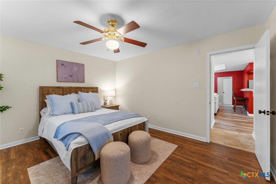 2504 Lazy Ridge Drive Killeen, TX 76543 - Photo 15 of 27 a bedroom with a bed and wooden floor