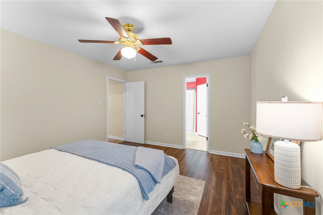 2504 Lazy Ridge Drive Killeen, TX 76543 - Photo 16 of 27 a bedroom with a bed and a chandelier