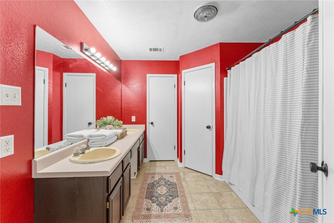 2504 Lazy Ridge Drive Killeen, TX 76543 - Photo 17 of 27 a bathroom with a sink vanity granite tub and shower