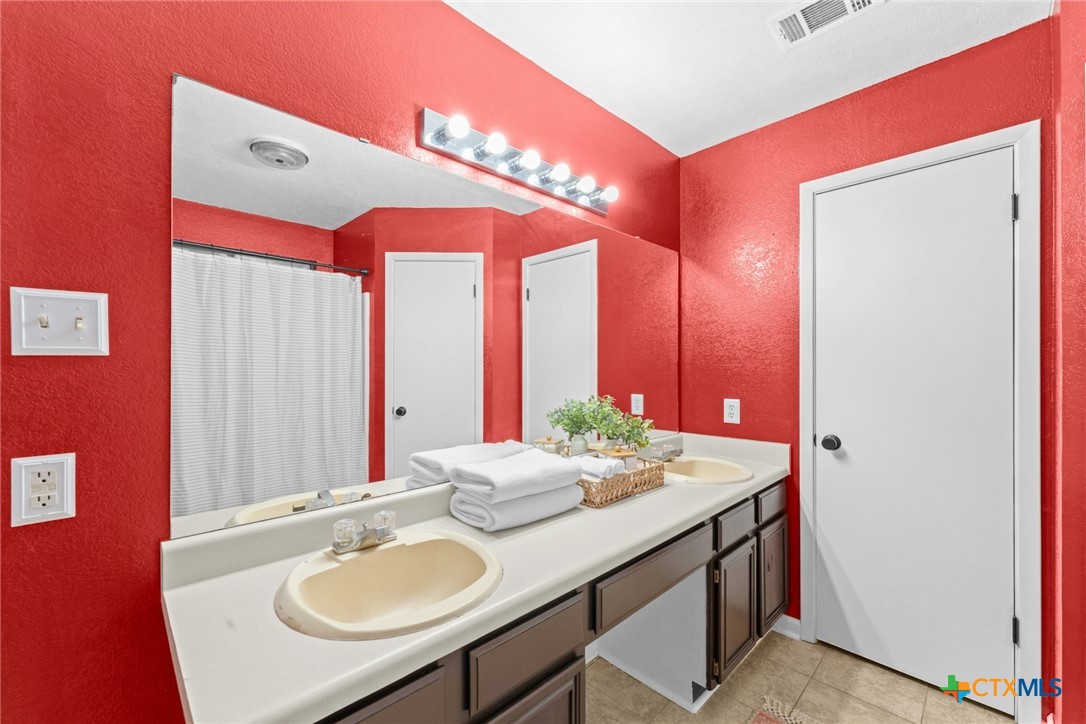 2504 Lazy Ridge Drive Killeen, TX 76543 - Photo 18 of 27 a bathroom with a sink vanity and a mirror