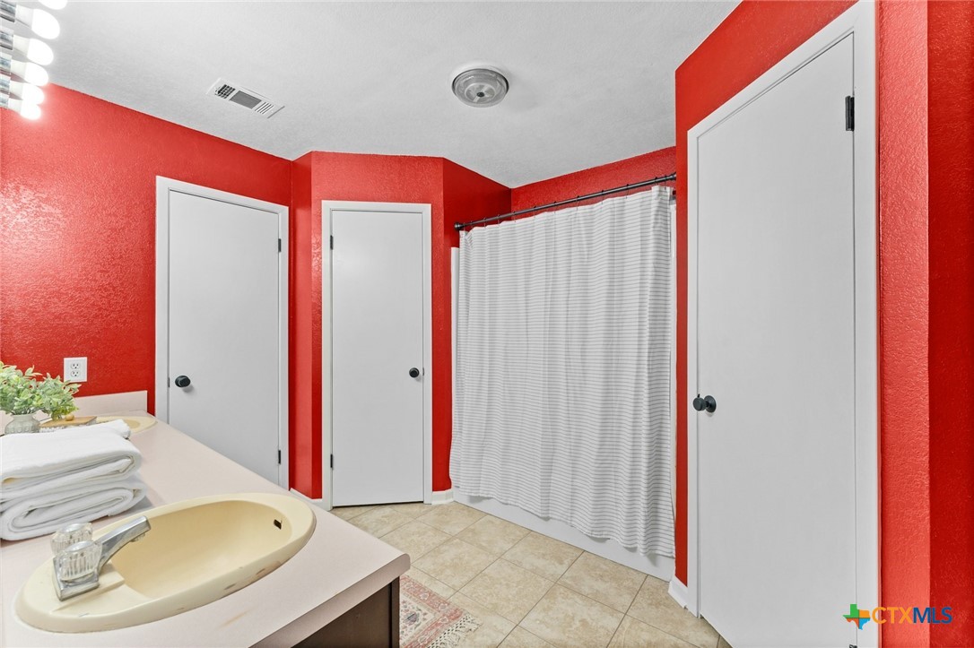 2504 Lazy Ridge Drive Killeen, TX 76543 - Photo 19 of 27 a bathroom with a sink and a mirror