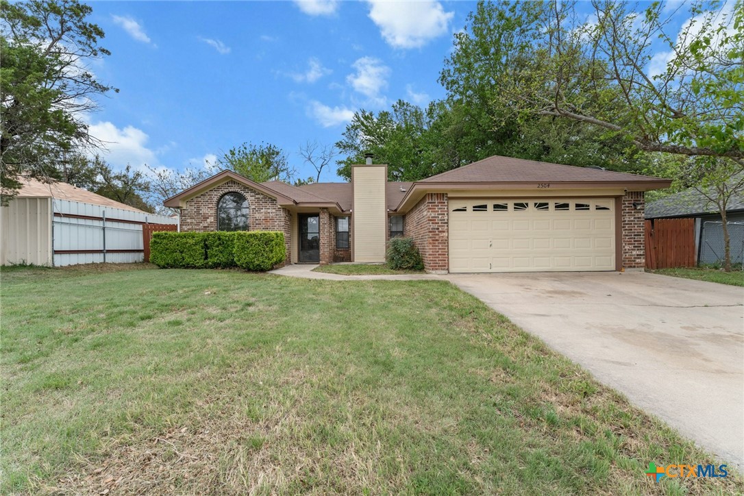 2504 Lazy Ridge Drive Killeen, TX 76543 - Photo 2 of 27 a front view of a house with a yard and garage