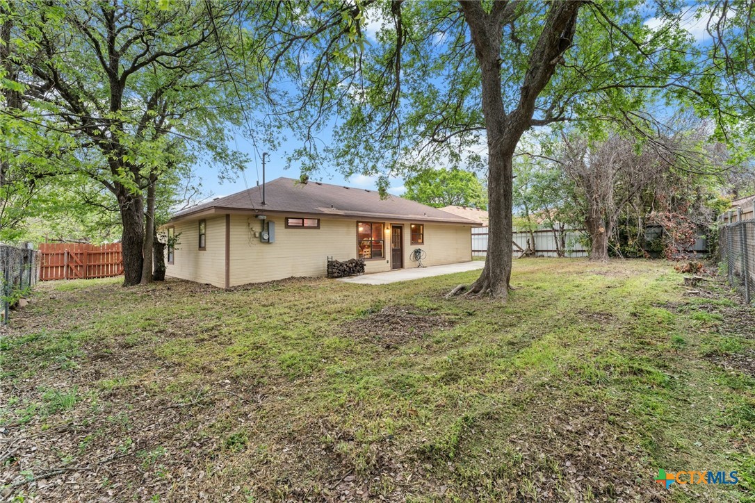 2504 Lazy Ridge Drive Killeen, TX 76543 - Photo 26 of 27 a backyard of a house with large trees and entertaining space