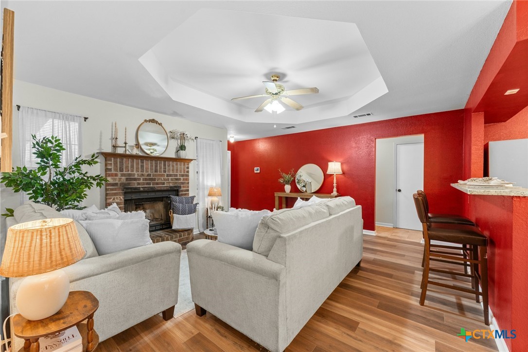 2504 Lazy Ridge Drive Killeen, TX 76543 - Photo 7 of 27 a living room with furniture a fireplace and a potted plant