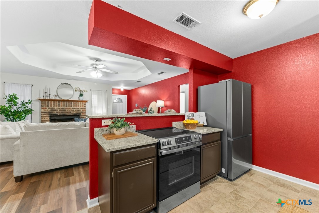 2504 Lazy Ridge Drive Killeen, TX 76543 - Photo 10 of 27 a kitchen with stainless steel appliances granite countertop a stove and a refrigerator