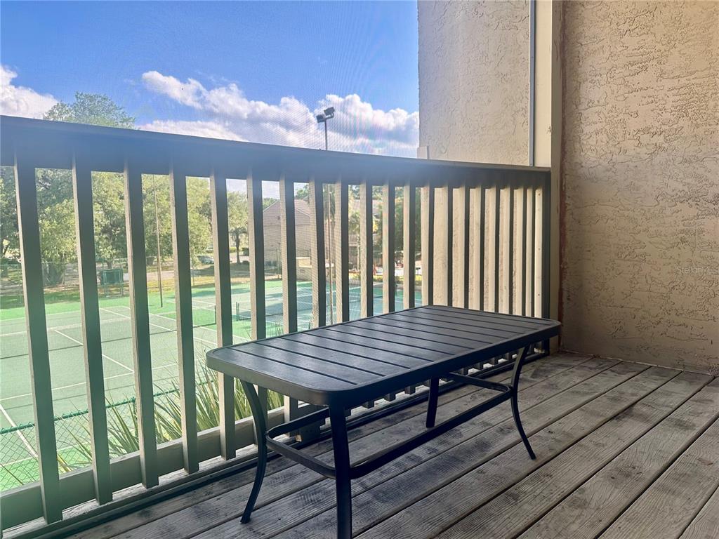 435 Wymore Road, Unit 207 Altamonte Springs, FL 32714 - Photo 11 of 17 a view of a wooden table and chairs on the roof deck
