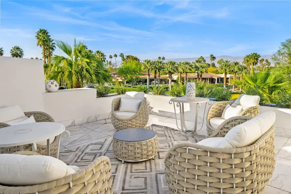 a view of a chairs and table in patio