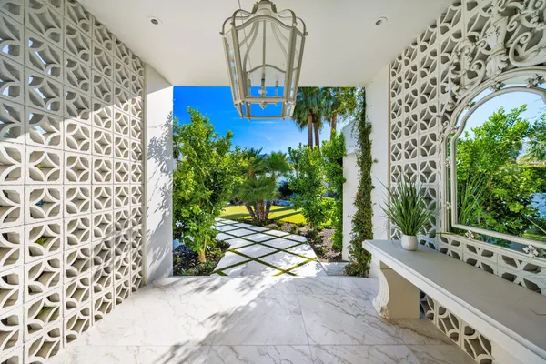 a view of spacious bathroom with a potted plant