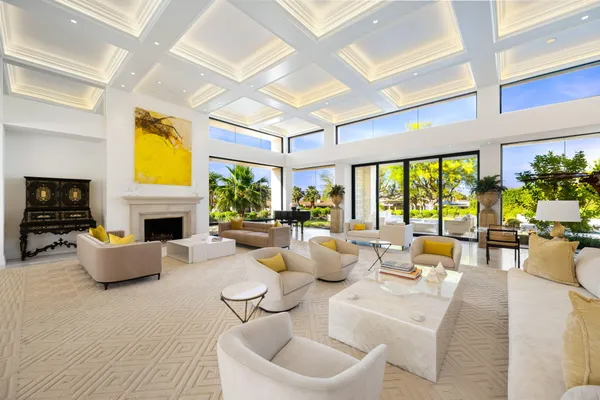 a living room with fireplace furniture and a large window