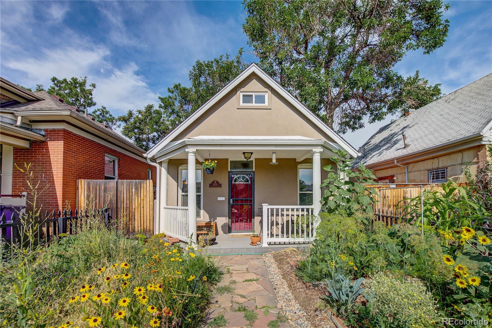 4251 Decatur Street Denver, CO 80211 - Photo 32 of 32 a view of a house with potted plants and a large tree
