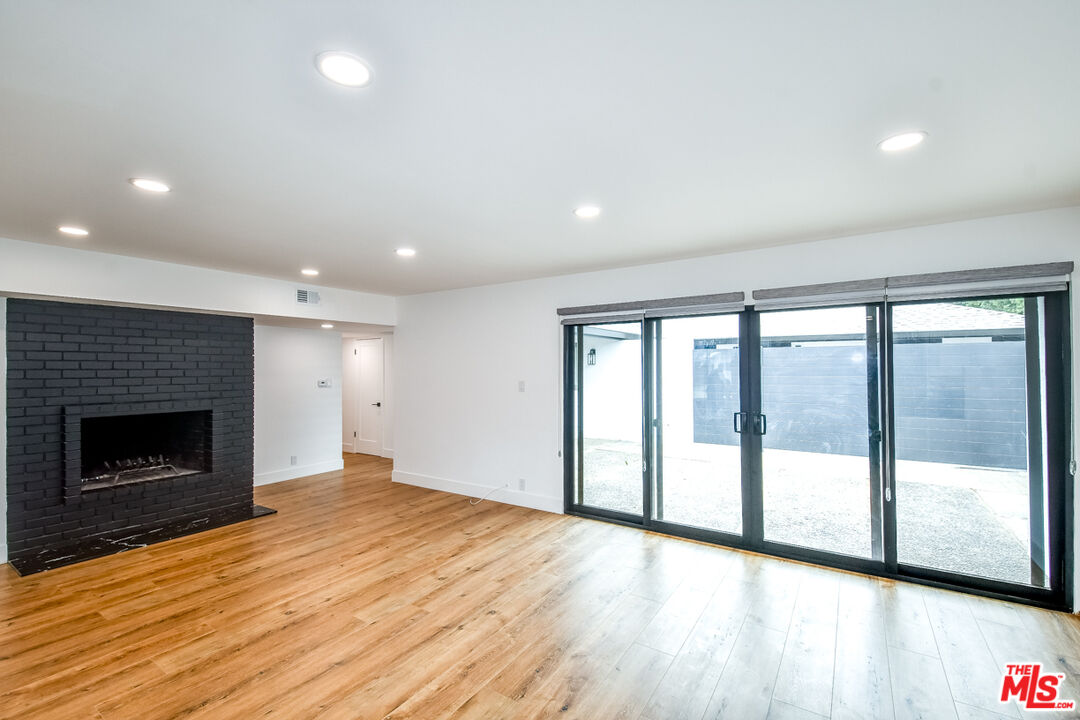 270 Grace Drive South Pasadena, CA 91030 - Photo 3 of 8 an empty room with wooden floor fireplace and windows