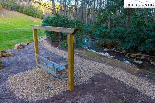 a view of a wooden deck with a backyard